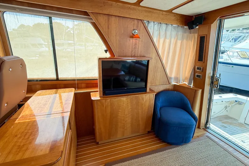 Slide: The Image of Interior of 2007 Sabre 52 Salon Express yacht with wood paneling and blue chair. - 13