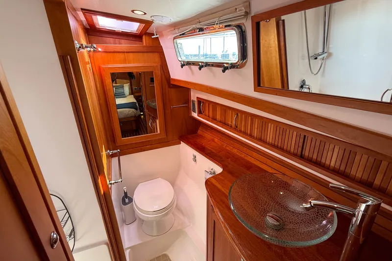 Slide: The Image of Luxurious 2007 Sabre 52 Salon Express yacht bathroom with elegant wood finish and modern fixtures. - 34