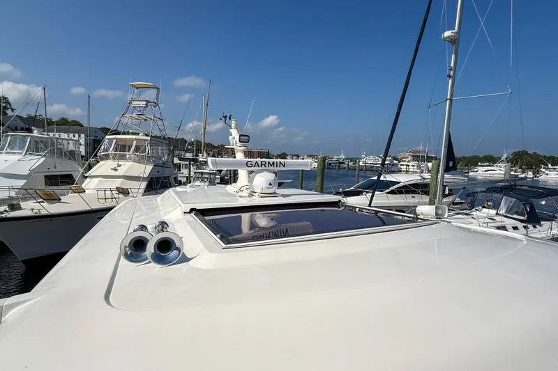 Slide: The Image of 2007 Sabre 52 Salon Express yacht docked at marina under clear blue sky. - 54