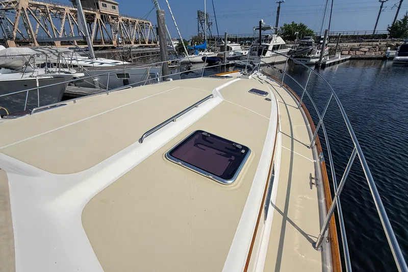 Slide: The Image of 2007 Sabre 52 Salon Express yacht docked at marina, showcasing deck and railings. - 46