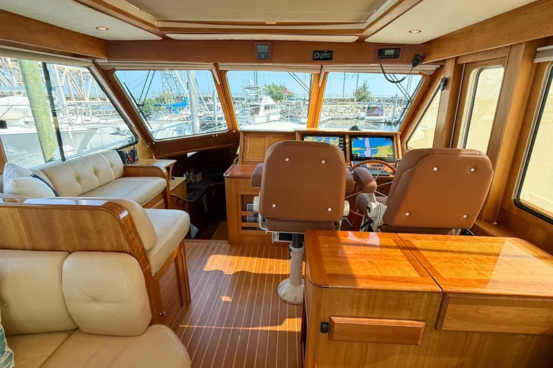 Slide: The Image of Luxurious interior of a 2007 Sabre 52 Salon Express yacht with plush seating and wooden finishes. - 15