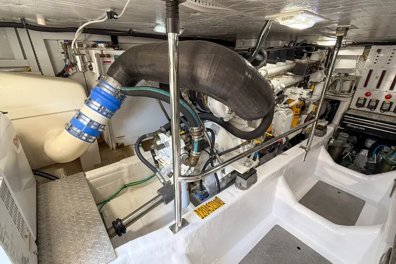 Slide: The Image of Engine room of 2007 Sabre 52 Salon Express yacht, showcasing mechanical components and piping. - 59