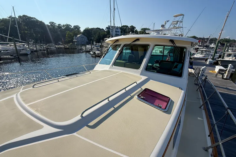 Slide: The Image of 2007 Sabre 52 Salon Express yacht docked at a marina under clear skies. - 50