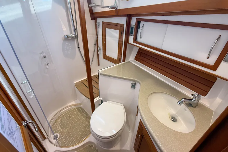 Slide: The Image of 2007 Sabre 52 Salon Express bathroom with shower, sink, and wooden accents. - 42