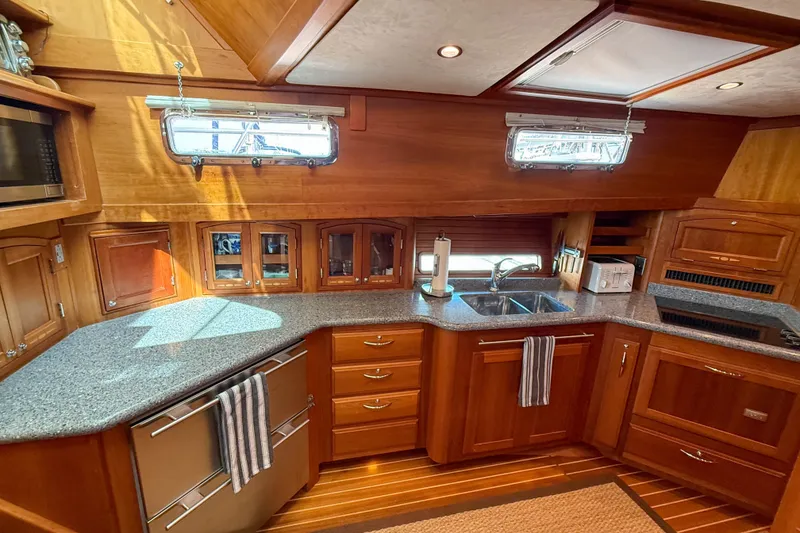 Slide: The Image of Luxurious 2007 Sabre 52 Salon Express yacht kitchen with wood cabinetry and modern appliances. - 25