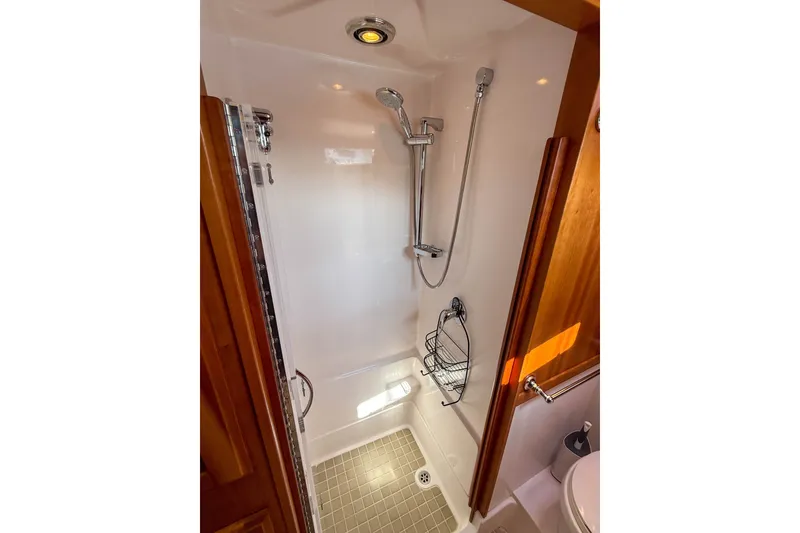 Slide: The Image of Shower area in 2007 Sabre 52 Salon Express yacht, featuring modern fixtures and wooden accents. - 36