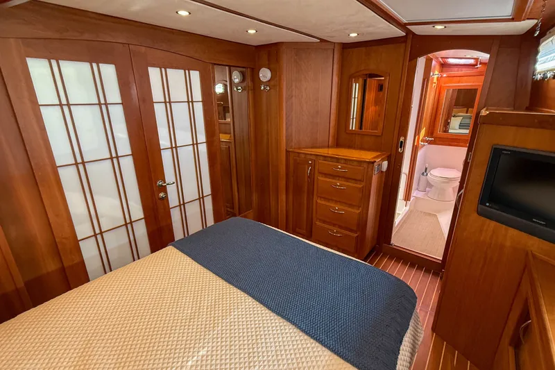Slide: The Image of Luxurious 2007 Sabre 52 Salon Express yacht interior with wood paneling and elegant bedroom. - 33