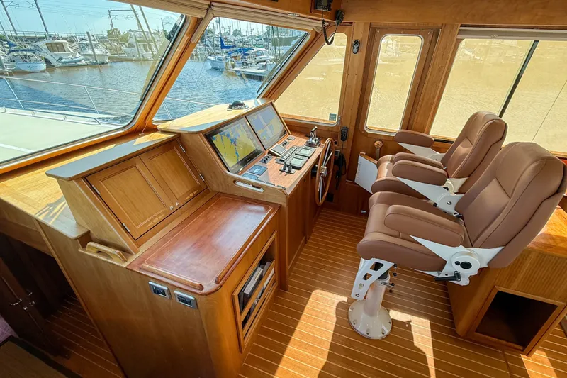 Slide: The Image of Interior of 2007 Sabre 52 Salon Express yacht with helm, navigation screens, and leather seats. - 17