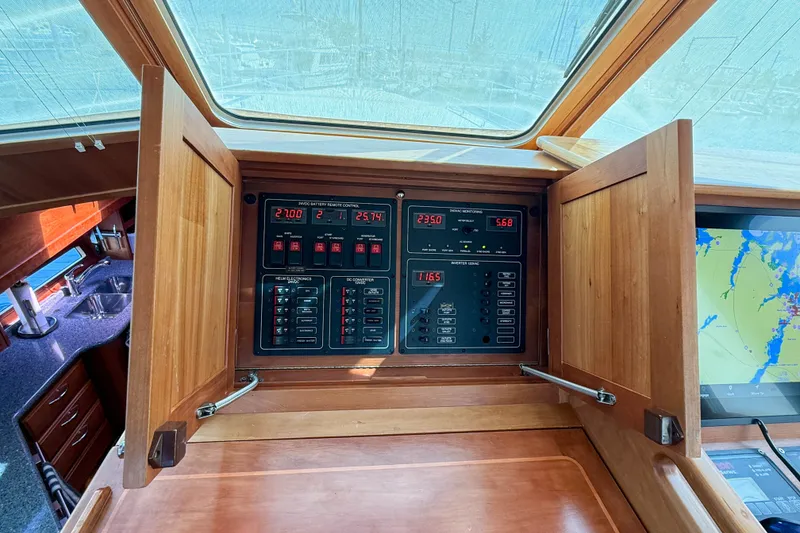 Slide: The Image of Control panel inside 2007 Sabre 52 Salon Express yacht, featuring navigation and monitoring systems. - 67
