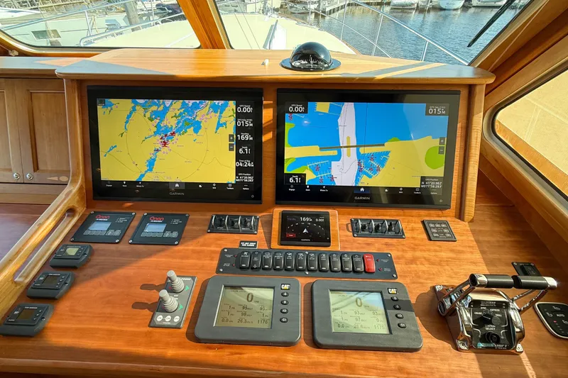 Slide: The Image of 2007 Sabre 52 Salon Express helm with navigation screens and controls. - 23