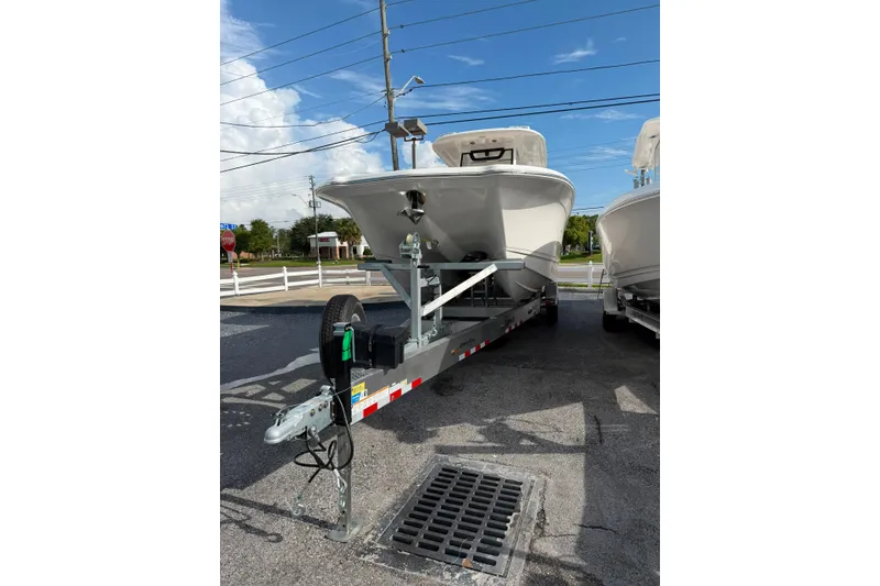 Slide: The Image of 2027 Caymas 29 CT boat on trailer, parked outdoors under clear blue sky. - 20