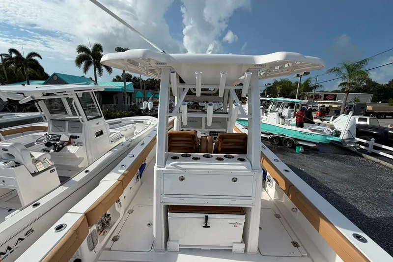 Slide: The Image of 2027 Caymas 29 CT boat with center console, docked under a clear sky. - 18