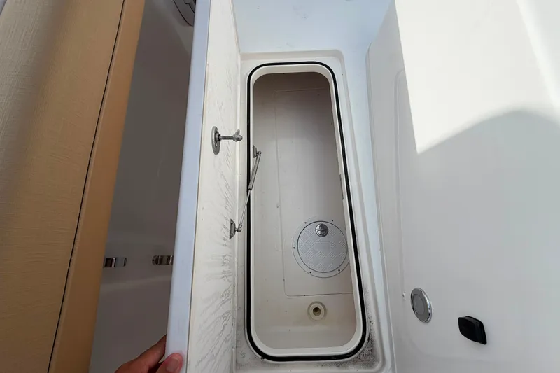 Slide: The Image of Open storage compartment on 2027 Caymas 29 CT boat, showcasing interior space. - 16