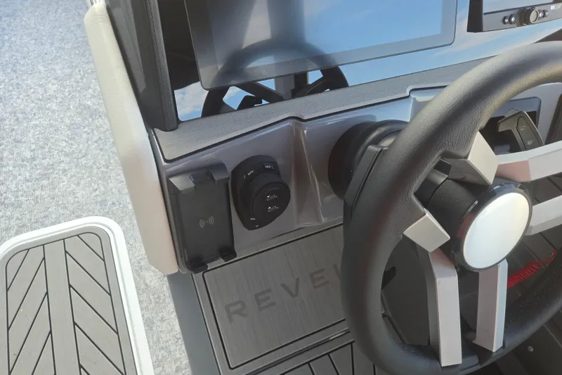 Slide: The Image of Steering console of 2027 Revel RS25L boat with modern controls and display. - 14