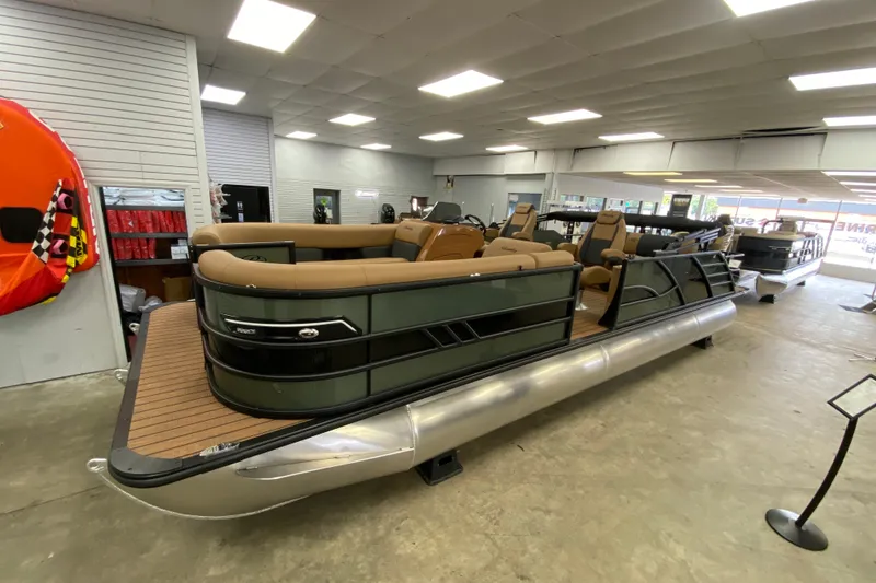 Slide: The Image of 2026 Bentley Pontoons Elite 253 Swingback in showroom, featuring luxurious seating and sleek design. - 17
