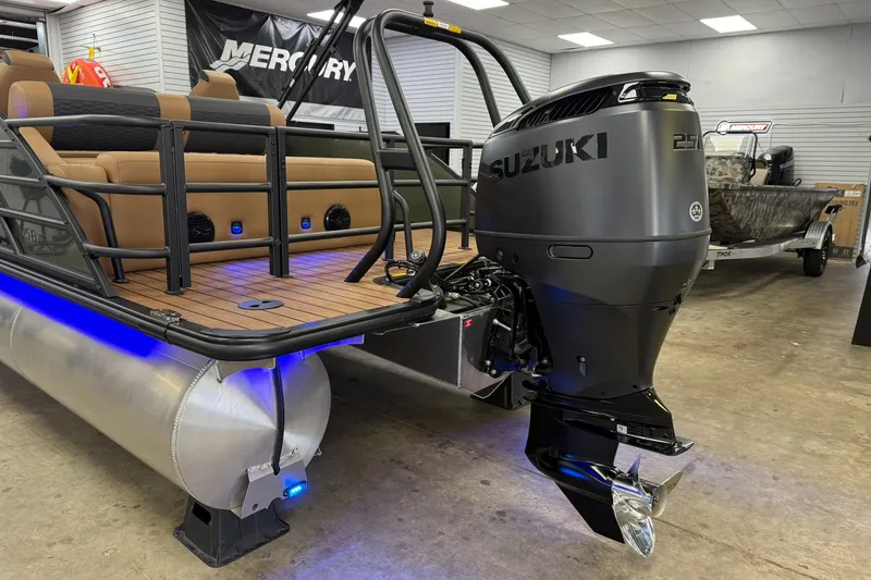 Slide: The Image of 2026 Bentley Pontoons Elite 253 Swingback with Suzuki outboard motor in showroom. - 16