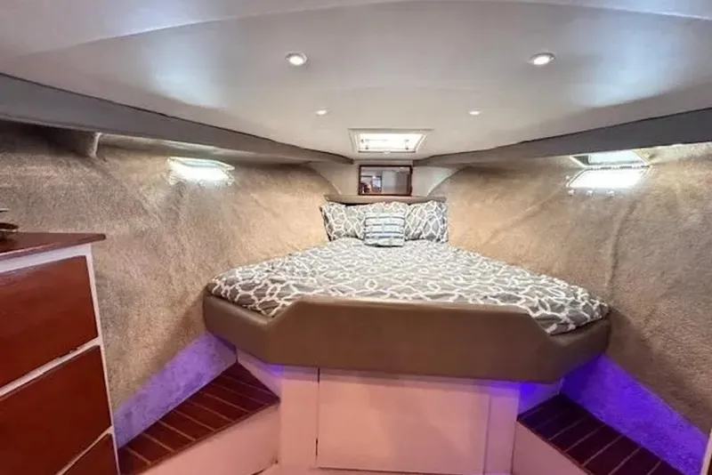 Slide: The Image of Cozy cabin interior of 1981 Ocean Yachts 42 Super Sport with patterned bedding. - 17
