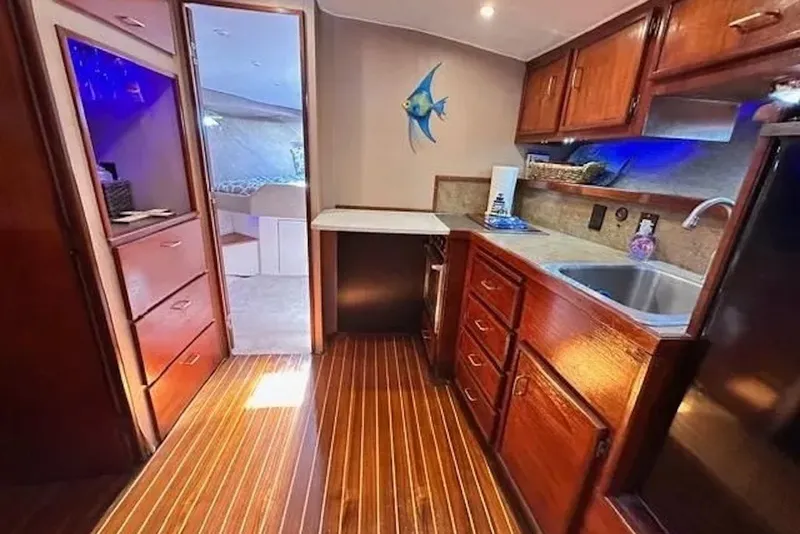 Slide: The Image of Interior of 1981 Ocean Yachts 42 Super Sport with wooden cabinetry and modern amenities. - 16