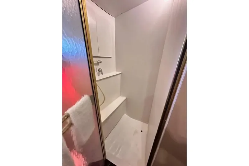 Slide: The Image of Shower area in 1981 Ocean Yachts 42 Super Sport, featuring white interior and glass door. - 20