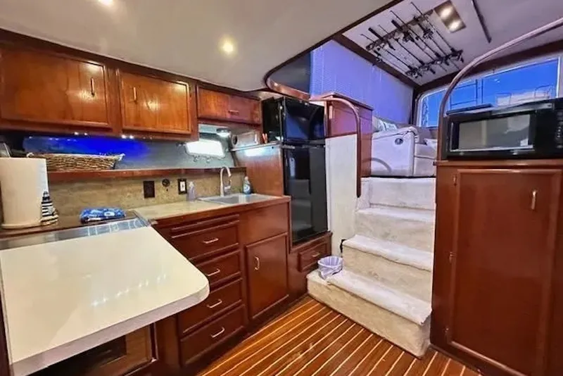 Slide: The Image of Luxurious interior of 1981 Ocean Yachts 42 Super Sport with wooden cabinetry and modern amenities. - 15