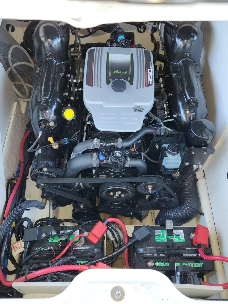 Slide: The Image of The engine compartment of a 2015 Sea Ray 220 Sundeck with a powerful engine and batteries. - 32