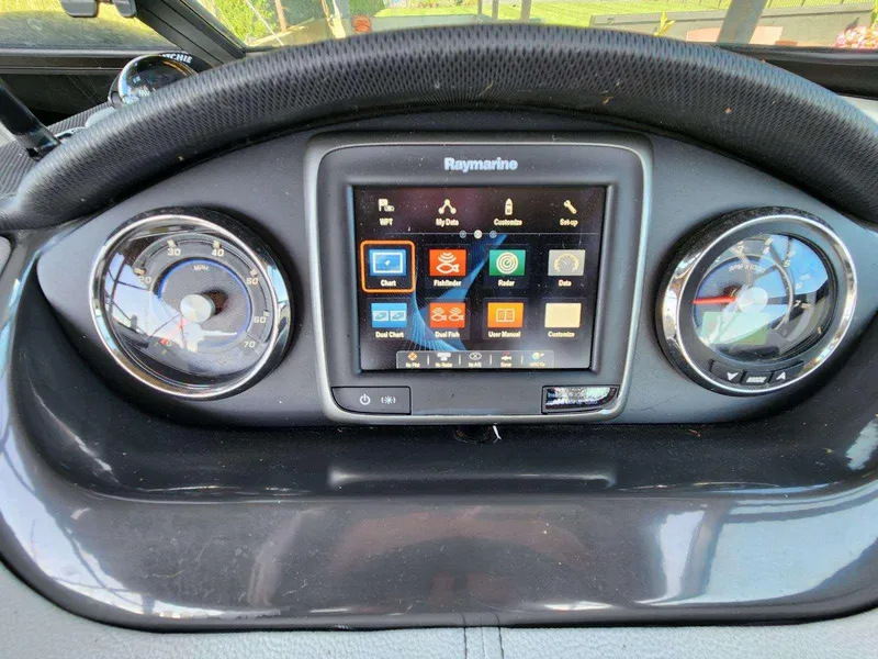 Slide: The Image of The image shows the dashboard of a Sea Ray 220 Sundeck boat with a Raymarine display. - 25