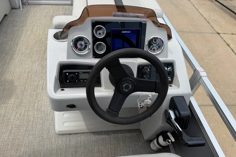 Slide: The Image of Steering console of 2021 Avalon 2280 Venture Quad Lounger with gauges and controls. - 14