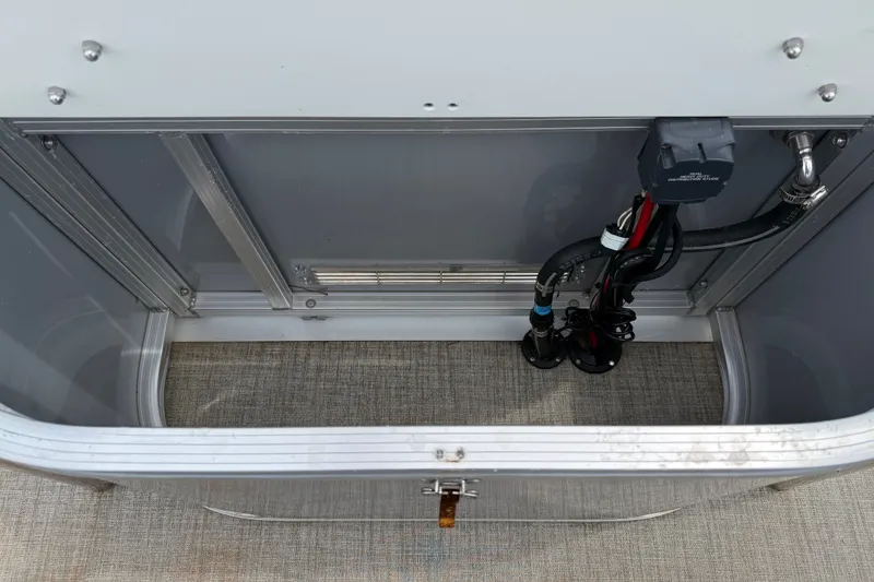 Slide: The Image of Storage compartment of 2021 Avalon 2280 Venture Quad Lounger with wiring and hoses visible. - 23