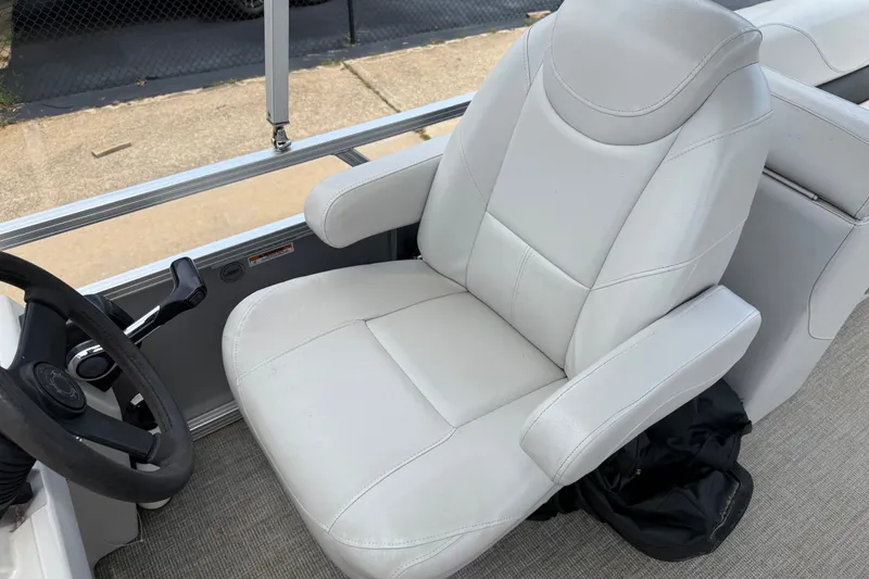 Slide: The Image of 2021 Avalon 2280 Venture Quad Lounger captain's chair with steering wheel, showcasing luxury design. - 18