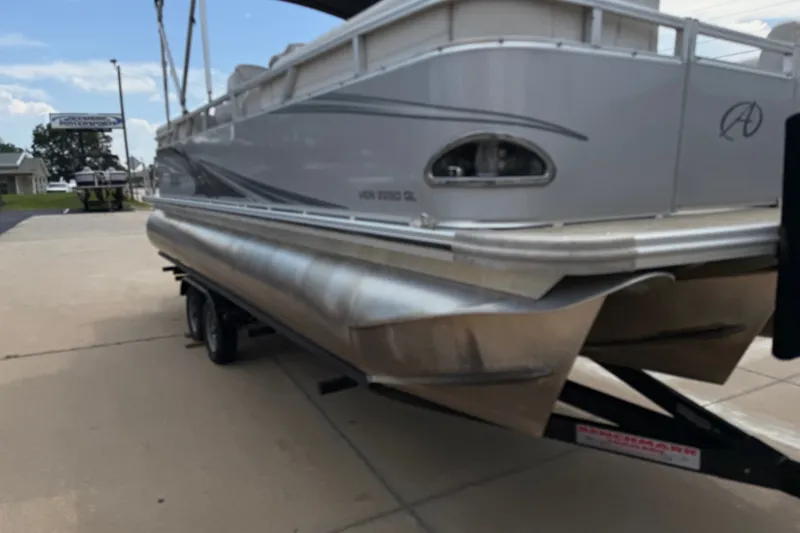 Slide: The Image of 2021 Avalon 2280 Venture Quad Lounger pontoon boat on trailer, parked outdoors. - 5