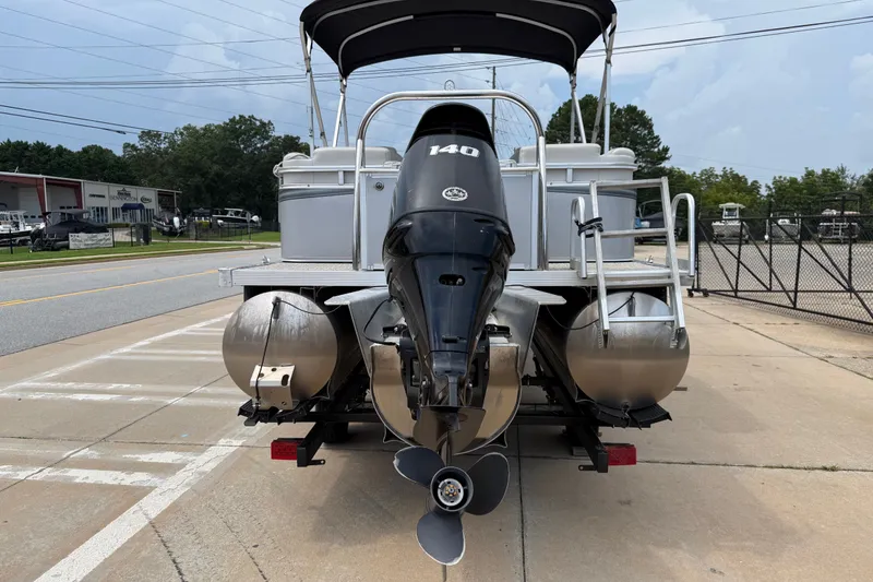 Slide: The Image of 2021 Avalon 2280 Venture Quad Lounger pontoon boat with 140 HP engine, parked outdoors. - 3