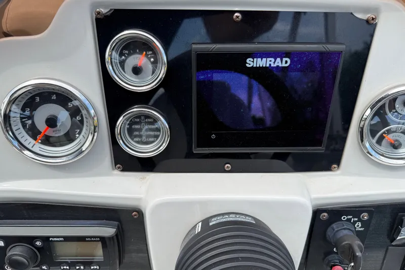 Slide: The Image of Dashboard of 2021 Avalon 2280 Venture Quad Lounger with Simrad display and gauges. - 15