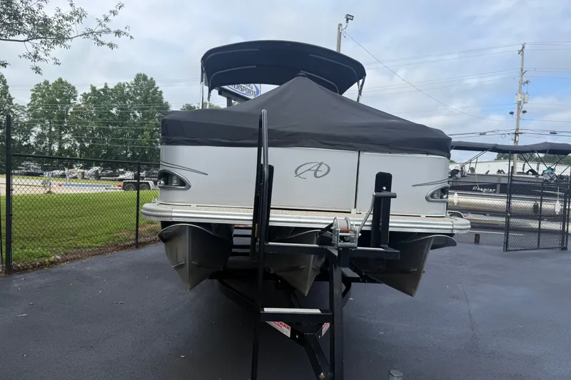 Slide: The Image of 2021 Avalon 2280 Venture Quad Lounger pontoon boat on trailer, covered and parked outdoors. - 7