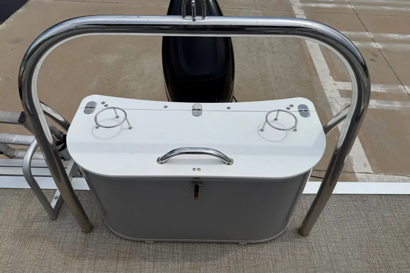 Slide: The Image of 2021 Avalon 2280 Venture Quad Lounger boat with stainless steel railing and storage compartment. - 22