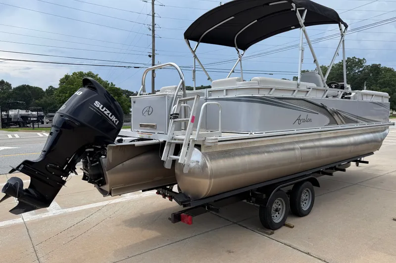 Slide: The Image of 2021 Avalon 2280 Venture Quad Lounger pontoon boat on trailer with Suzuki outboard motor. - 4