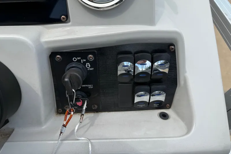 Slide: The Image of Control panel of 2021 Avalon 2280 Venture Quad Lounger with ignition and switches. - 17