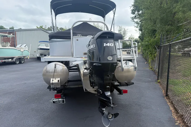 Slide: The Image of 2021 Avalon 2280 Venture Quad Lounger with Suzuki 140 outboard motor, parked outdoors. - 9