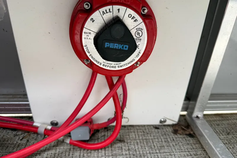 Slide: The Image of Battery switch on a 2021 Avalon 2280 Venture Quad Lounger with red cables. - 25