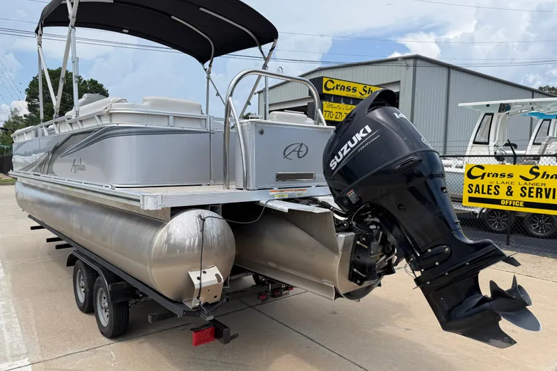 Slide: The Image of 2021 Avalon 2280 Venture Quad Lounger pontoon boat with Suzuki outboard motor on trailer. - 2