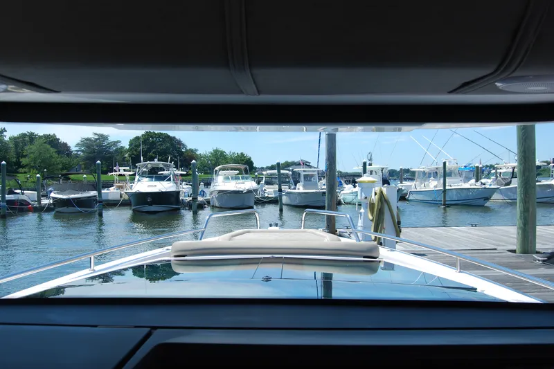 Slide: The Image of View from 2022 Axopar 37 XC Cross Cabin, overlooking marina with docked boats. - 18