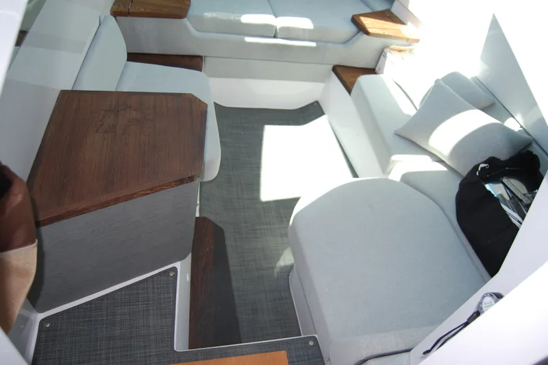 Slide: The Image of Interior of 2022 Axopar 37 XC Cross Cabin with modern seating and wooden accents. - 25