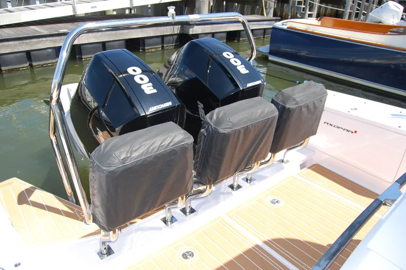 Slide: The Image of 2022 Axopar 37 XC Cross Cabin with dual Mercury 300 engines at dock. - 27