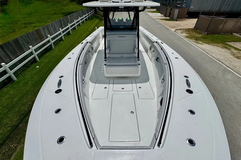Slide: The Image of 2024 SeaHunter 33 Tournament boat, spacious deck view, sleek design, white finish. - 18
