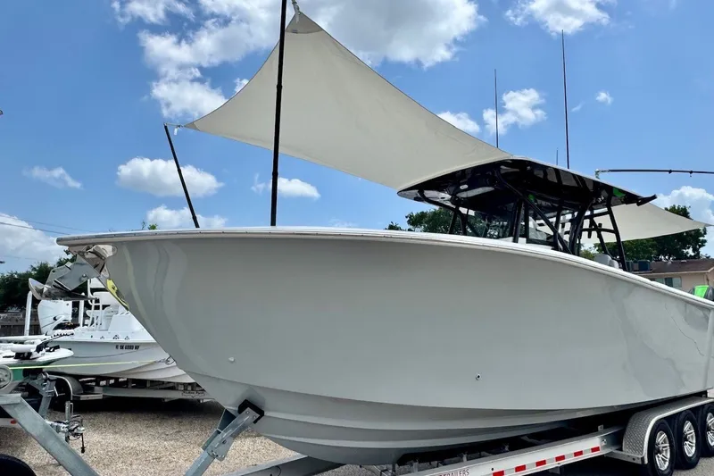 Slide: The Image of 2024 SeaHunter 33 Tournament boat on trailer under blue sky with clouds. - 23