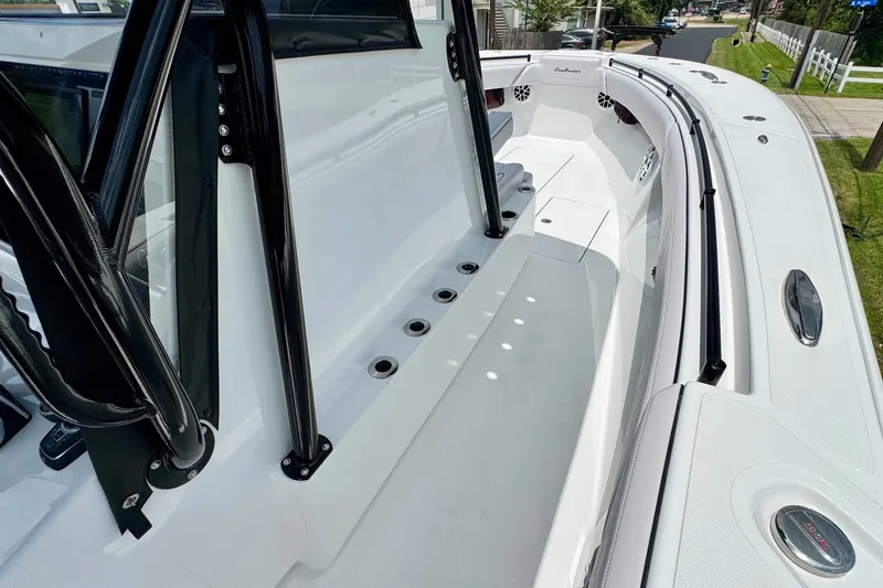 Slide: The Image of 2024 SeaHunter 33 Tournament boat deck with sleek design and rod holders. - 17