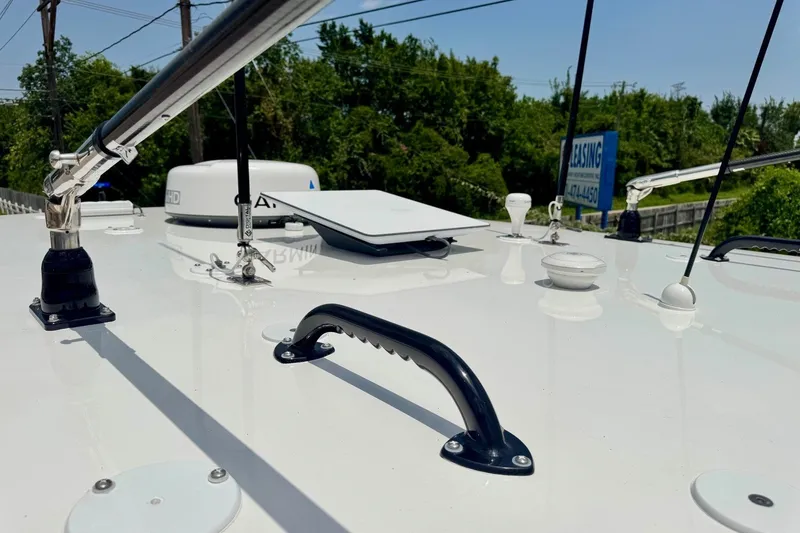 Slide: The Image of 2024 SeaHunter 33 Tournament boat deck with equipment and railing under clear sky. - 21
