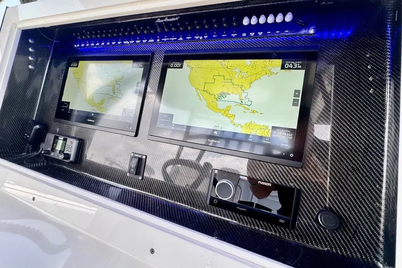 Slide: The Image of 2024 SeaHunter 33 Tournament dashboard with dual Garmin navigation screens and carbon fiber finish. - 19