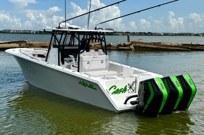 Slide: The Image of 2024 SeaHunter 33 Tournament boat with triple 400 engines on calm water. - 26
