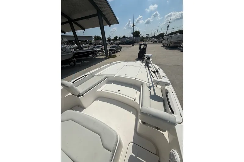 Slide: The Image of 2021 Sea Cat 260 boat docked, showcasing spacious deck and seating area under sunny skies. - 14