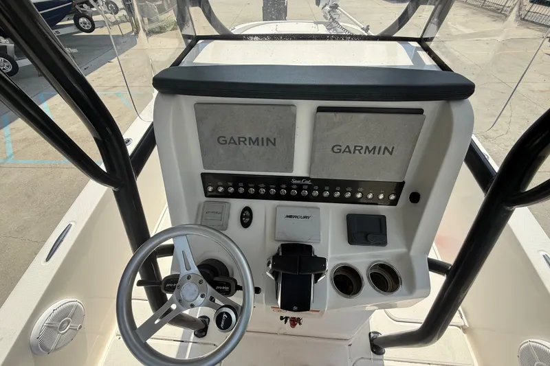 Slide: The Image of 2021 Sea Cat 260 boat dashboard with Garmin displays and Mercury controls. - 16